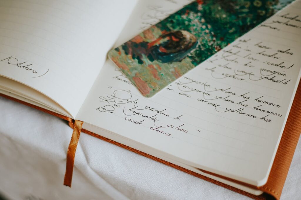 A close-up of an open journal with handwritten text and a colorful bookmark, evoking creativity.